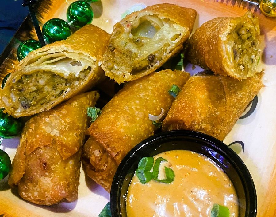 Crispy fried boudin egg rolls with a dipping sauce