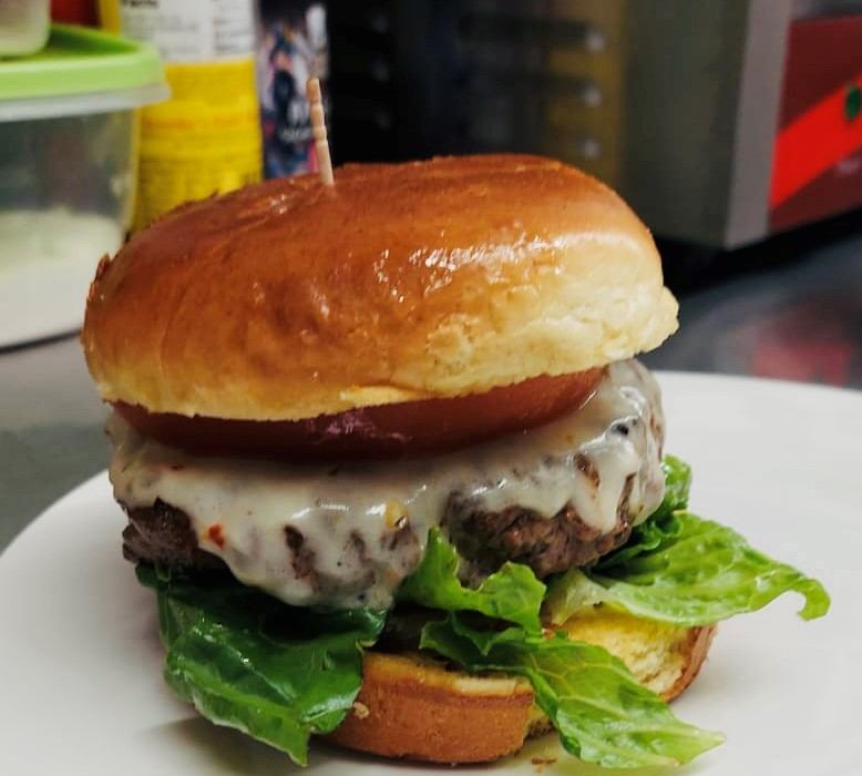 A half-pound cheeseburger on a toasted bun with lettuce