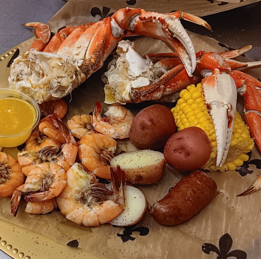 Crab legs, shrimp, potatoes and corn on a seafood platter